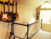 4 guitar wallhanger above a staircase