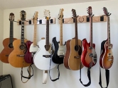8 guitars hanging on wall