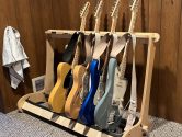Wood guitar stand holding 4 electric guitars