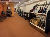 hallway of a recording studio, filled with instruments and chairs