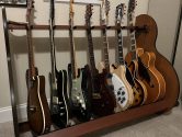 7 electric guitars in a wooden guitar stand