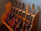 red oak guitar stand holding 7 instruments