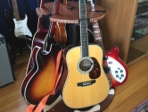 acoustic and electric guitars in the Carousel Deluxe rotating stand