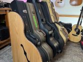 acoustic-guitar-cases-in-wood-rack