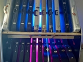 guitar shelves backlit with trippy blue and purple lights
