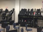 guitar case racks lining a cinderblock wall