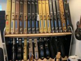 electric and acoustic guitar cases on shelves