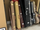guitar cases in a wood rack