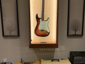 fender strat in an L.E.D. display cabinet, place above amplifiers