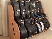 red oak guitar case storage rack filled with cases