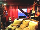 guitar collection next to a piano and couch