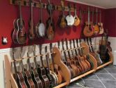 red and white room filled with guitar stands and wall mounts