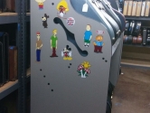 side view of guitar shelf rack covered in stickers