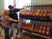 two people pointing at their guitar shelf storage rack
