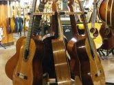 wood guitar stand holding 6 acoustic guitars