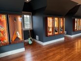 wall filled with guitar lit display cabinets