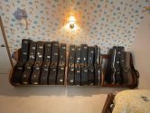 three guitar case racks against a wall