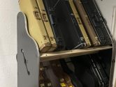 guitar shelves against brick cinderblock walll