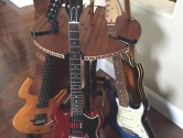 rotating wood multi guitar stand with mahogany surface