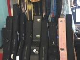 guitar cases resting in a storage rack