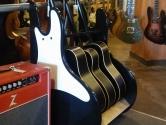 retro guitar rack, with pickguard, next to a red amplifier