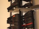 two two-tiered guitar shelves holding instrument cases