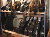 guitars and cases filling shelves