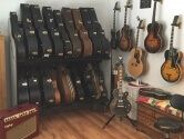 music room with guitar case shelves and wall hangers