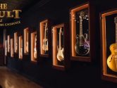 guitars in lit display cases lining the walls of the Vault Room at Chicago Music Exchange