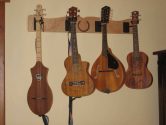 wood wall hanger holding ukeleles and mandolins