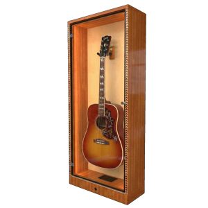 An angled shot of a Gibson Hummingbird guitar in a mahogany display case