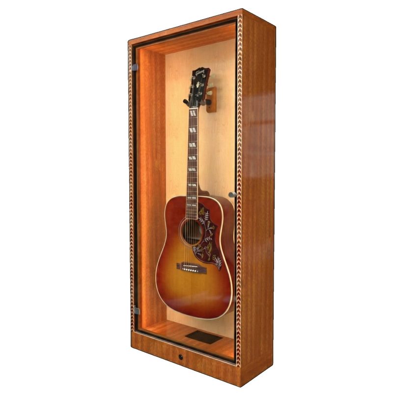 An angled shot of a Gibson Hummingbird guitar in a mahogany display case