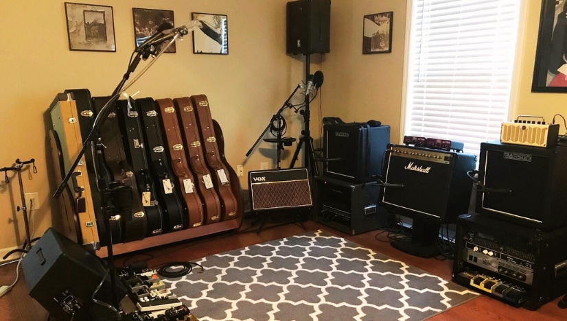 Home recording studio with carpet, guitar cases, amps and microphones